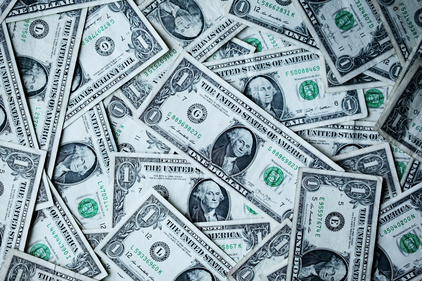 Close-up image of dollar bills laying flat on table; founders early money habits