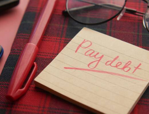 a note that says pay debt next to a pen and glasses; free truck