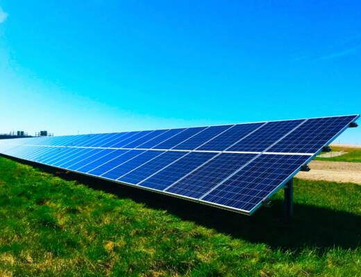Solar panel in green field on clear sunny day; when solar promises fail